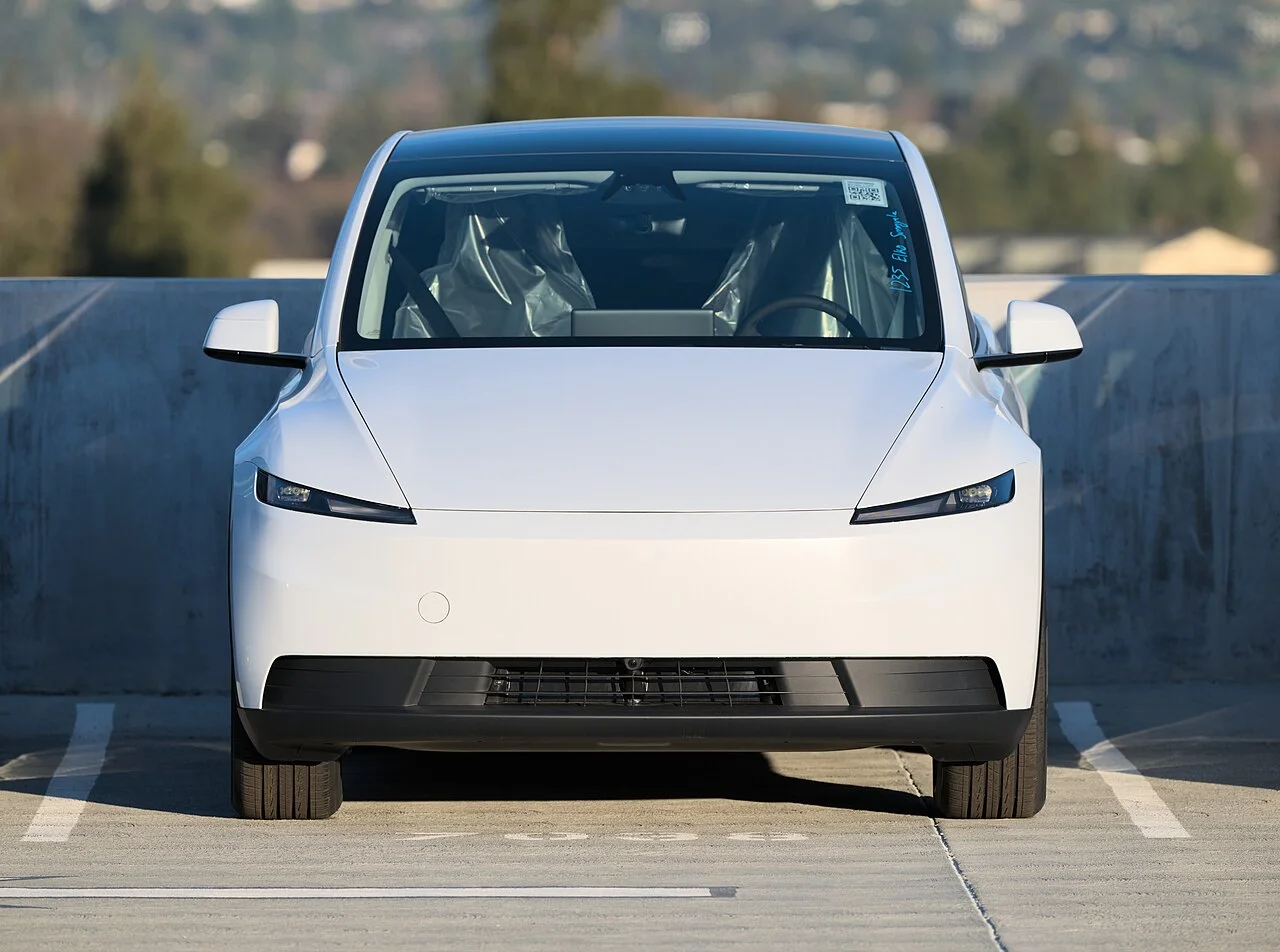 Front view of a white 2025 Tesla Model Y Standard parked outdoors